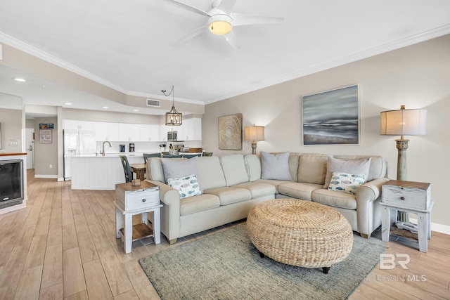 26200 Perdido Beach Blvd Unit 1403, Orange Beach, AL 36561 - living area with crown molding, a ceiling fan, and light wood-style floors