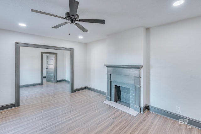 unfurnished living room featuring ceiling fan and light wood-type flooring