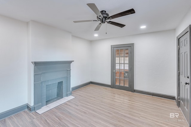 unfurnished living room featuring ceiling fan and light hardwood / wood-style flooring