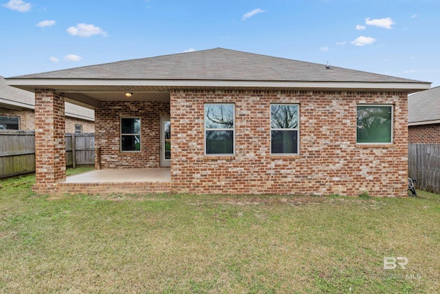 back of house with a lawn and a patio area