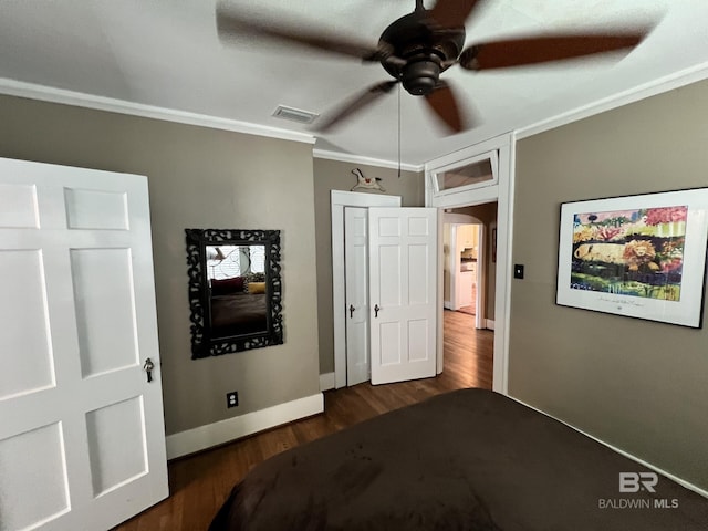 bedroom with ornamental molding, dark wood-type flooring, and ceiling fan