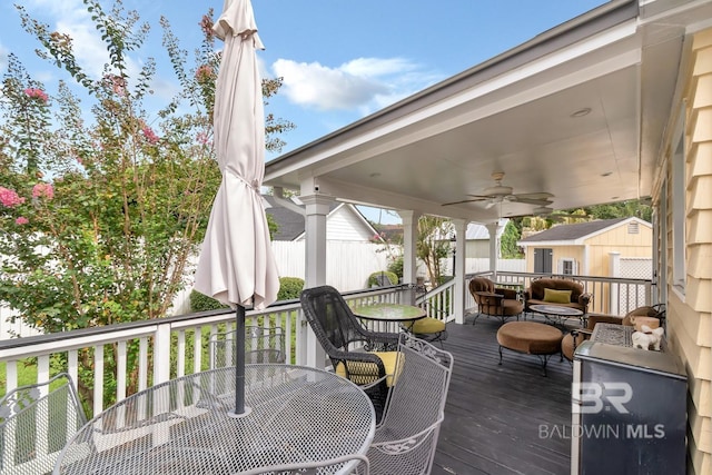 deck featuring a storage unit and ceiling fan