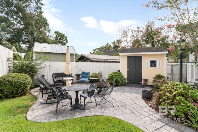 view of patio / terrace featuring a shed and an outdoor fire pit