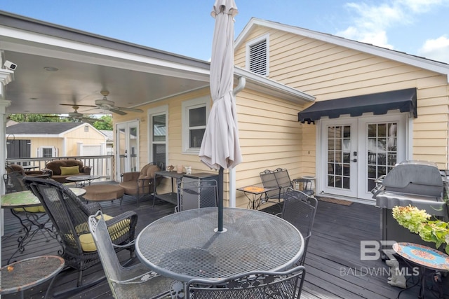 deck with a grill, ceiling fan, an outdoor structure, and french doors