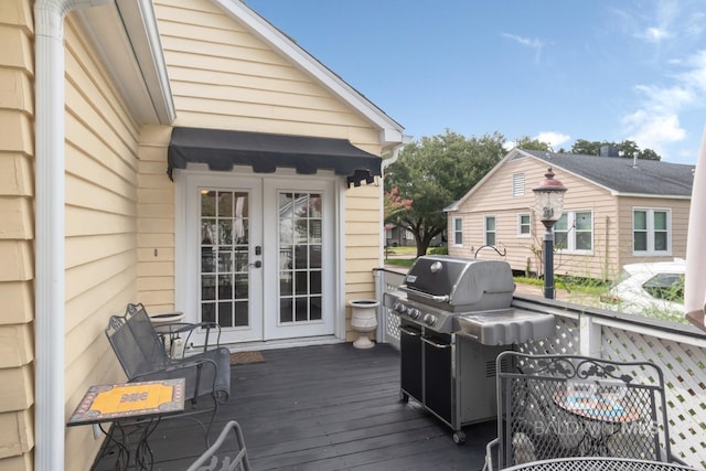 wooden deck featuring french doors and a grill