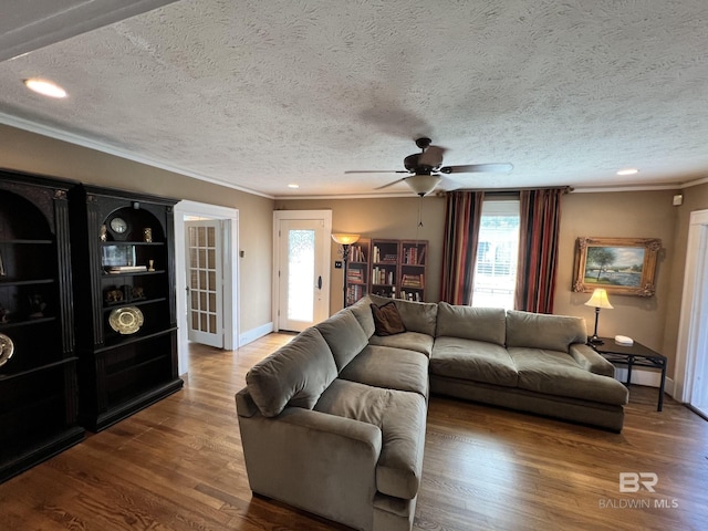 living room featuring a textured ceiling, ceiling fan, and hardwood / wood-style floors