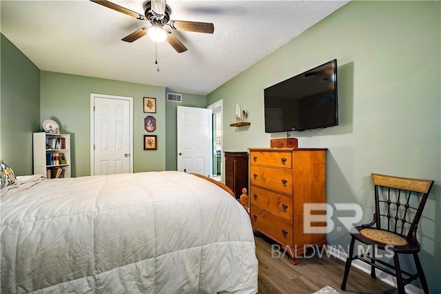 bedroom featuring ceiling fan, a textured ceiling, and hardwood / wood-style flooring