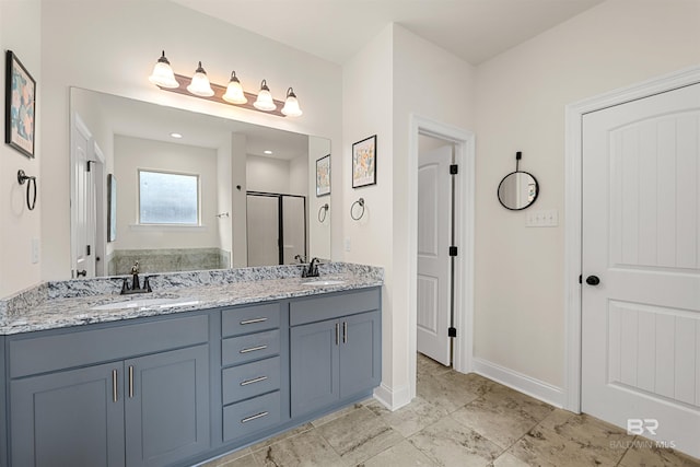 bathroom featuring vanity and a shower with door