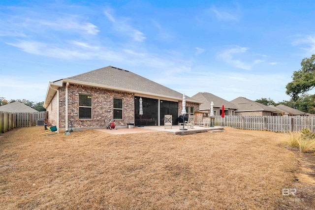 rear view of house with a patio area and a lawn