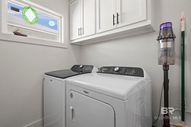 washroom featuring cabinet space and washing machine and dryer