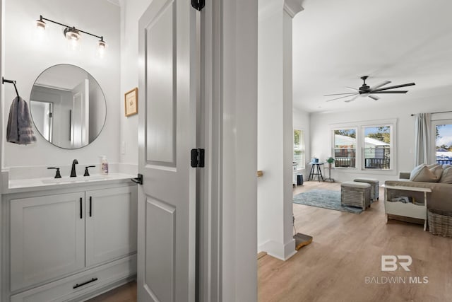 bathroom with ceiling fan, wood finished floors, and vanity