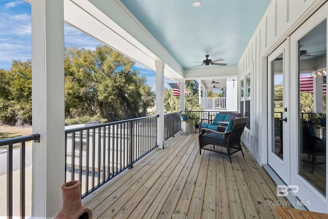 wooden terrace featuring ceiling fan