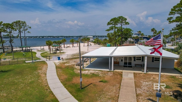 view of home's community featuring a patio area, a yard, a water view, and fence