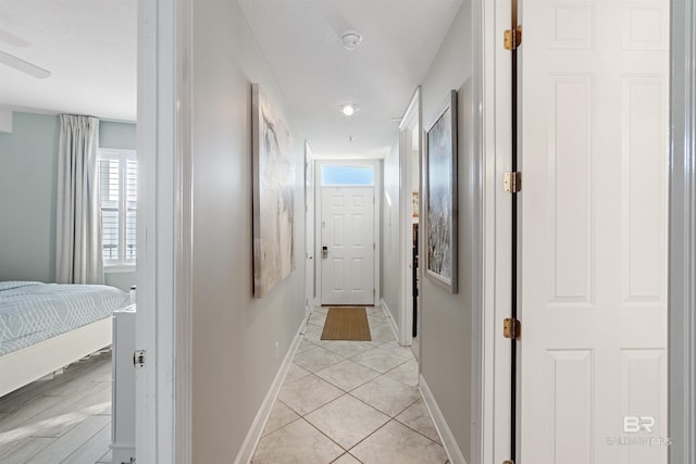 corridor featuring light tile patterned flooring