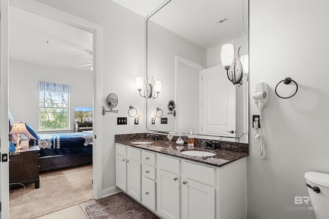 ensuite bathroom featuring a sink, visible vents, double vanity, and ensuite bathroom