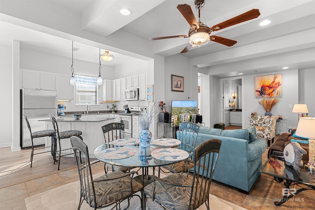 dining space with a ceiling fan, recessed lighting, and baseboards