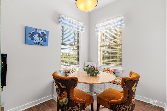 dining area featuring breakfast area, baseboards, and dark wood-style flooring