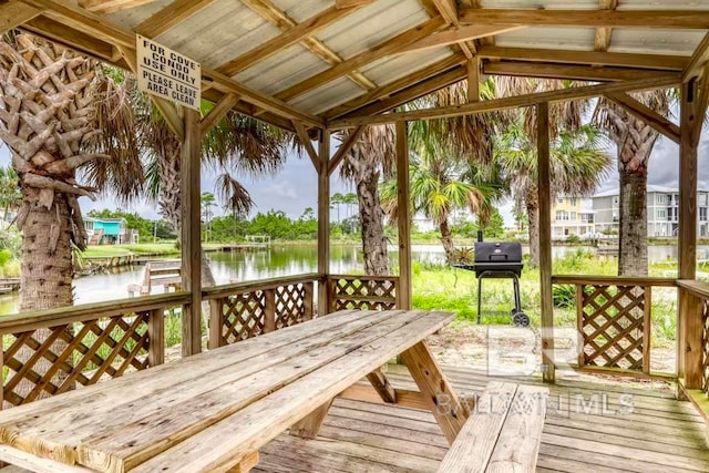 deck featuring a water view and a grill