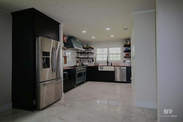 kitchen with light tile patterned flooring, wall chimney range hood, decorative backsplash, sink, and appliances with stainless steel finishes