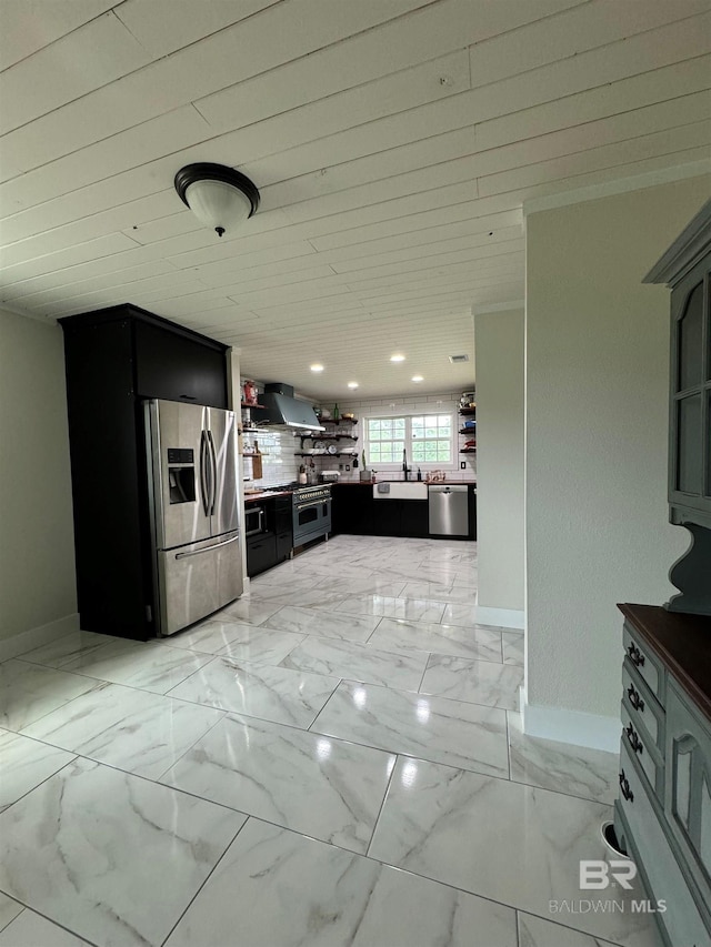 kitchen with appliances with stainless steel finishes, light tile patterned floors, and wall chimney exhaust hood