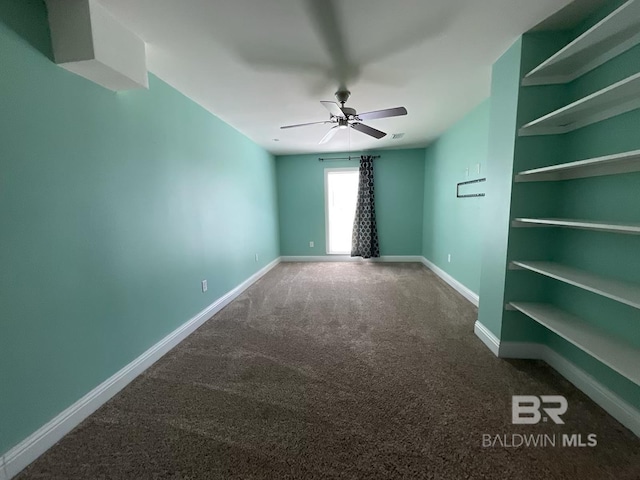 empty room featuring carpet flooring and ceiling fan