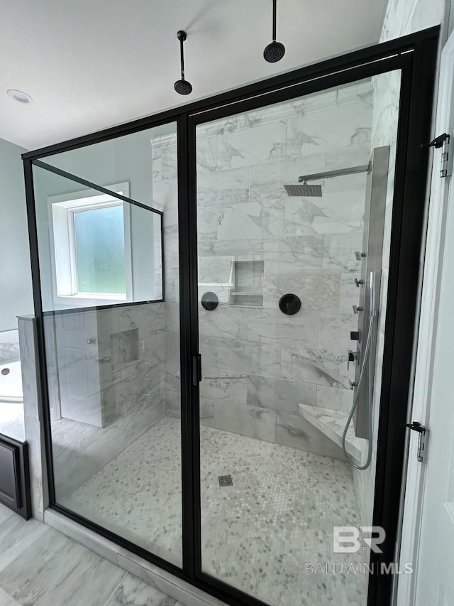 bathroom featuring walk in shower and tile patterned flooring