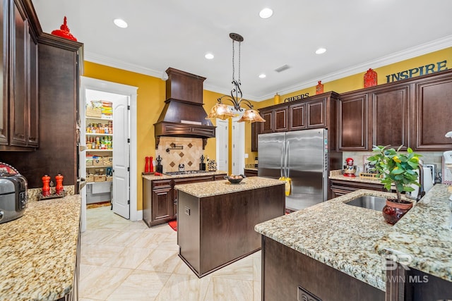 kitchen with a kitchen island, custom range hood, stainless steel appliances, tasteful backsplash, and light tile floors