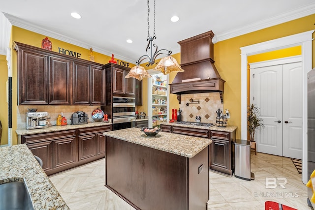 kitchen with tasteful backsplash, custom exhaust hood, a center island, appliances with stainless steel finishes, and pendant lighting