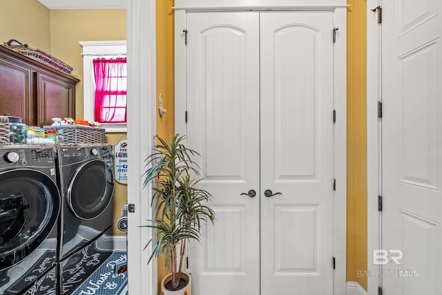 washroom with cabinets and separate washer and dryer