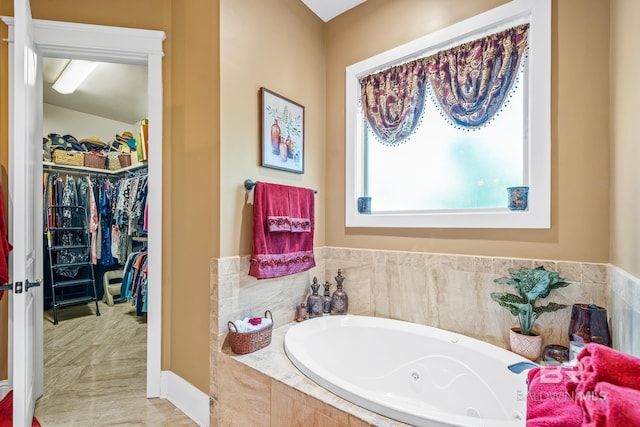 bathroom with tile flooring and tiled tub