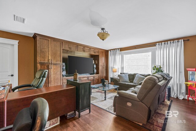 living room with dark hardwood / wood-style flooring