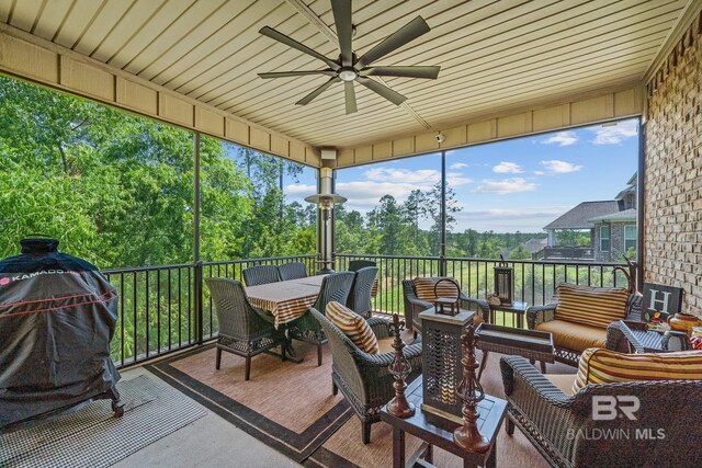 sunroom featuring ceiling fan