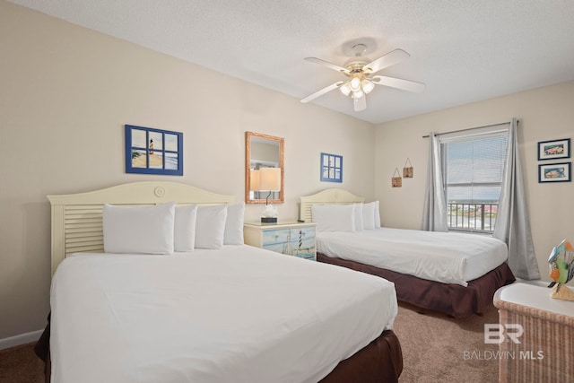 bedroom with ceiling fan, a textured ceiling, and carpet floors