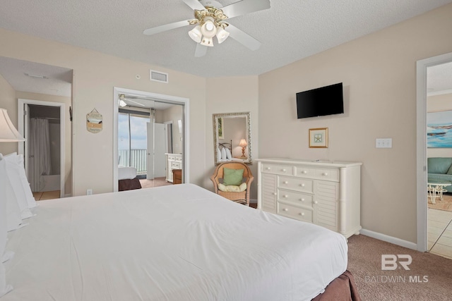 carpeted bedroom featuring a textured ceiling and ceiling fan