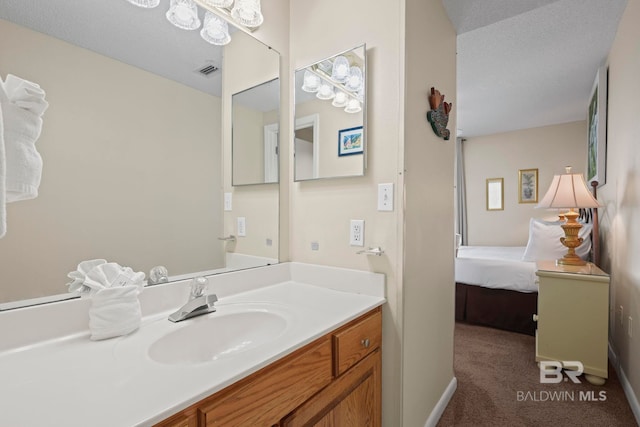 bathroom with a textured ceiling and vanity