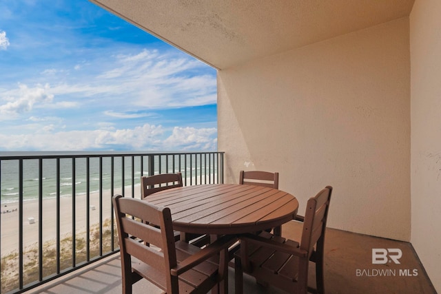 balcony with a view of the beach and a water view