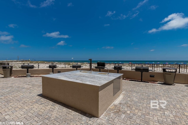 view of patio / terrace with a grill and a water view