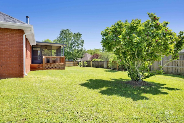 view of yard with a fenced backyard and a sunroom