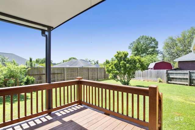 wooden deck featuring a yard and a fenced backyard