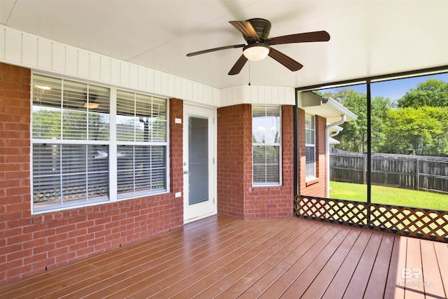 unfurnished sunroom with ceiling fan and a healthy amount of sunlight