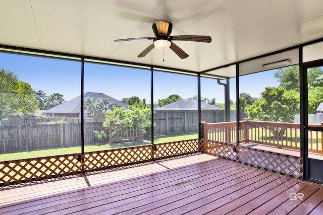 unfurnished sunroom with a ceiling fan