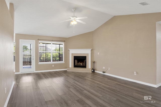 unfurnished living room featuring dark wood-type flooring, a fireplace with raised hearth, visible vents, lofted ceiling, and ceiling fan