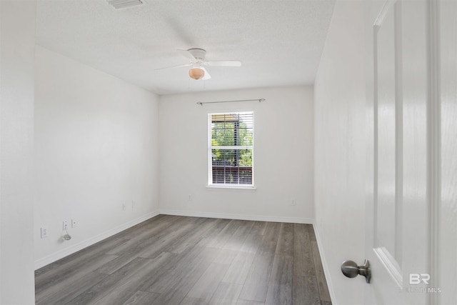 unfurnished room featuring visible vents, baseboards, a ceiling fan, a textured ceiling, and wood finished floors