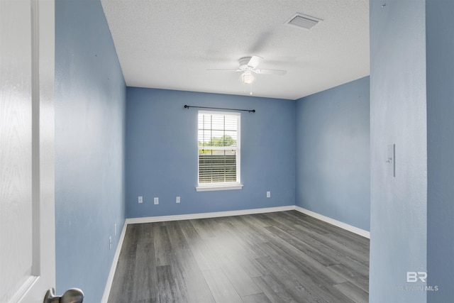 unfurnished room with visible vents, baseboards, wood finished floors, and ceiling fan