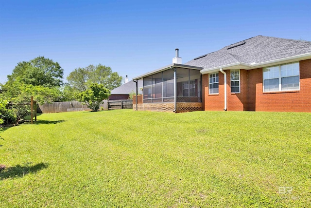 view of yard with a sunroom and a fenced backyard