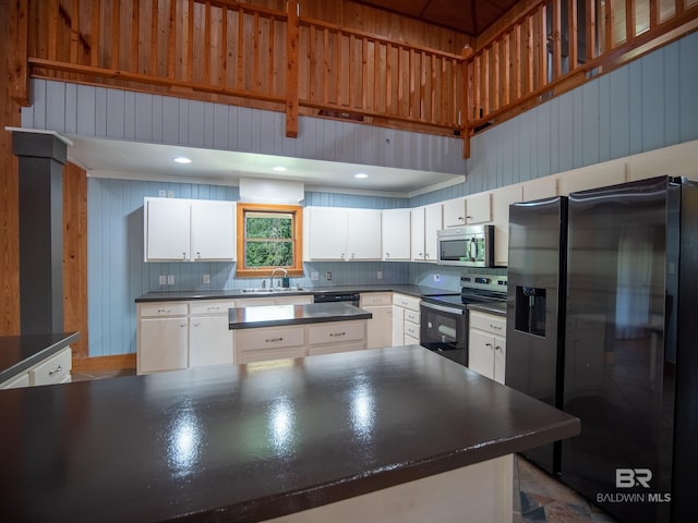 kitchen featuring decorative backsplash, white cabinets, stainless steel appliances, dark countertops, and a sink