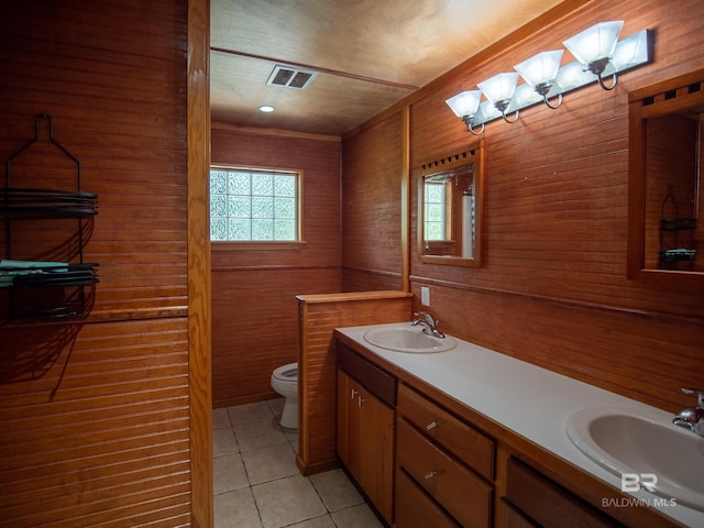 full bathroom with a sink, visible vents, toilet, and tile patterned flooring