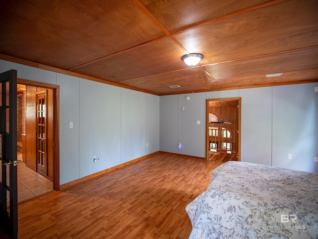 bedroom featuring light wood-style floors and wooden ceiling