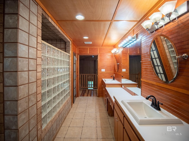 bathroom with tile patterned flooring, a sink, double vanity, and visible vents