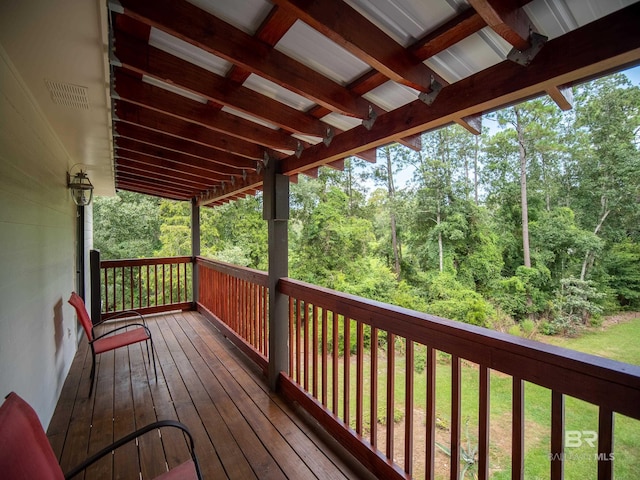 wooden deck featuring a yard